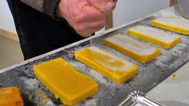 Cocinero espolvoreando az&uacute;car en turr&oacute;n de yema