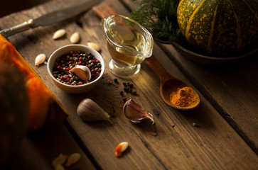 pumpkins with spices and greenery on the table  .ingredients for soup or other pumpkin dishes.healthy organic food .top view