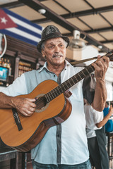 Obraz premium Havana, Cuba - October 18, 2019: Cuban band performing live music in a bar (Dos Hermanos) in Havana, Cuba.