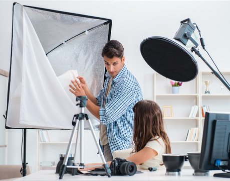 Young photographer working in photo studio