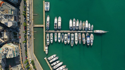 Aerial drone top down photo of yachts and sailboats docked in iconic round harbour of Zea or Passalimani, Piraeus, Attica, Greece