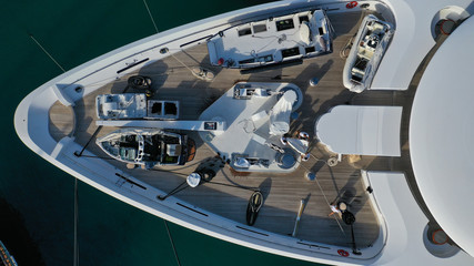 Aerial top down detail photo of yacht nose docked in tropical exotic bay with turquoise clear sea