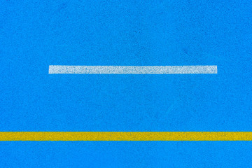 Fototapeta na wymiar Colorful sports court background. Top view blue field rubber ground with white and yellow lines outdoors