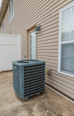 Air Conditioning Unit on Patio Behind Condo