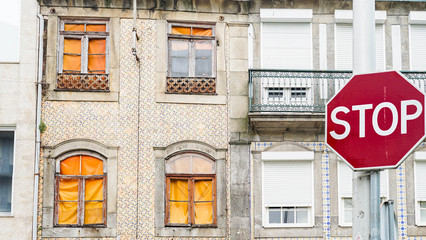 stop road sign against houses, buildings with azulejo in Portugal. closed city on coronavirus quarantine isolation. empty city, no tourists. 