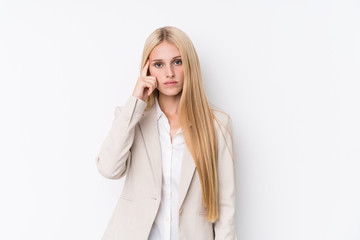 Young business blonde woman on white background pointing temple with finger, thinking, focused on a task.