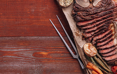 concept of a wonderful dinner for two of a delicious juicy fresh farmer marbled beef steak grilled with baked vegetables