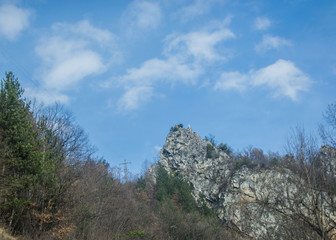 Mountain top in Bulgaria, with cross, beautiful forest and trees, power pole and cables on the background