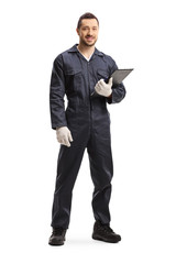 Naklejka na ściany i meble Worker standing and holding a clipboard