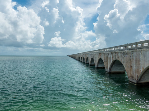 Old seven mile bridge at Florida keys with clouds and sea on a sunny day