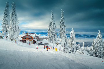 Ski resort with skiers on the slope, Poiana Brasov, Romania