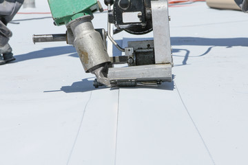 roofer joining white plastic sheets