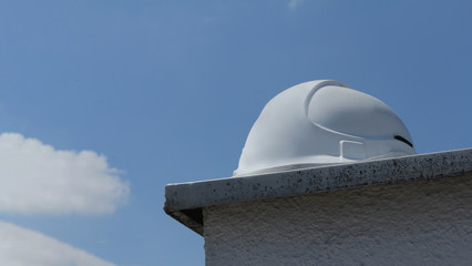 Fototapeta na wymiar white safety helmet on roof top