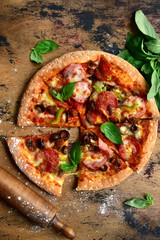 Homemade delicious meat pizza. Top view with copy space.