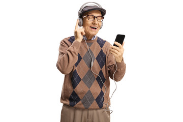 Cheerful elderly man listening to music from a mobile phone on headphones