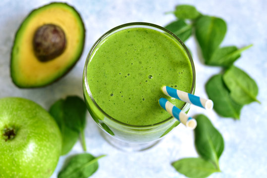 Detox green smoothie with apple, avocado and spinach. Top view with copy space.