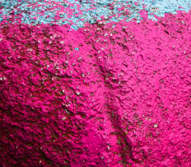 Old painted granite stone rock background. Pink, fuchsia, blue, cyan, turquoise, aquamarine, red
