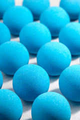 Blue bath bombs on white tabletop