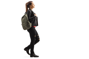 Young trendy female with a backpack walking