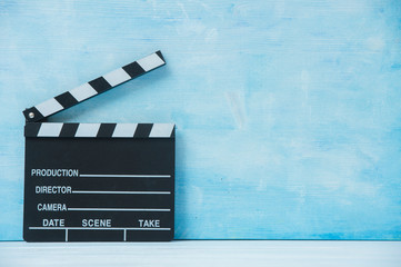 Movie clapper on blue background, cinema concept.