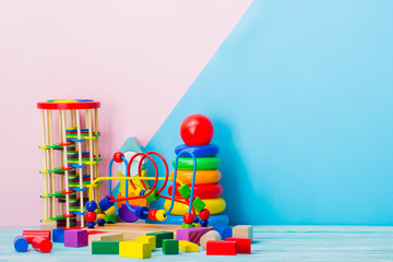 Colorful kids toys frame on wooden background. Top view. Flat lay. Copy space for text