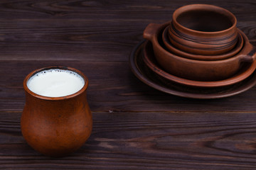 milk and earthenware on the wooden background