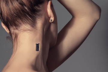 Usb charging port in woman's neck, cyborg woman concept.