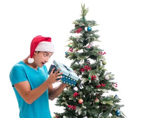 Young man decorating christmas tree isolated on white