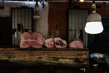 Street fish market. Carcass of sliced bluefin tuna on the table.