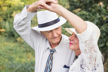 Seniors couple dancing in nature