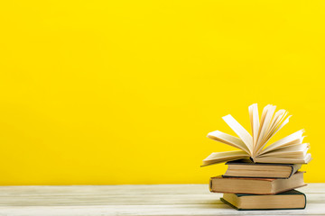 Open book, hardback books on wooden table. Back to school. Copy space.
