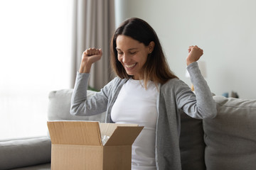 Cheery woman received long-awaited carton package feels happy
