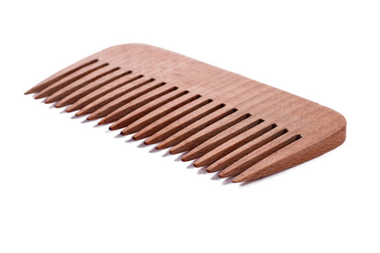 Wooden hair comb on white background. Wooden bamboo comb for hair care.