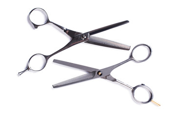 Hairdressing scissors on a white background. Steel hairdresser shears. Accessories for barbershop...
