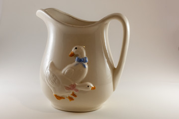 White pitcher with ducks on the front 