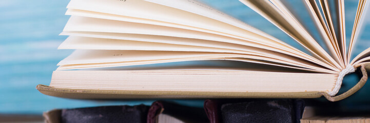 Open book, hardback books on wooden table. Back to school. Copy space