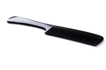 Black plastic hair comb on white background. Hair brush and copy space.
