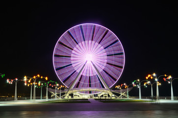 A Ferris Wheel in Baku on the shore of the Caspian Sea, at night with lights