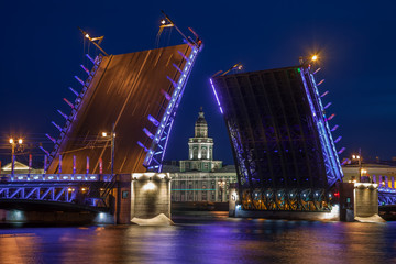 Fototapeta na wymiar Double-leaf bascule bridge (Palace Bridge) and Cabinet of curiosities (Kunstkammer) (Saint Petersburg, Russia). (Translation of the Russian text on flags: 'Welcome')