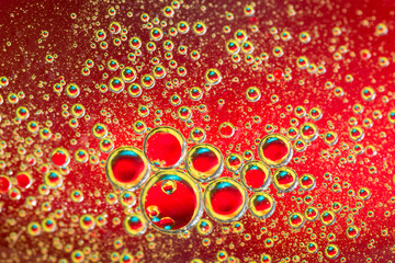 Water bubbles on red background. Scientific image of cell membrane. Macro up of liquid substances....