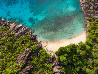 Top down aerial view of a beautiful deserted beach on the tropical island of the Seychelles