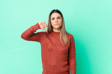 Young caucasian woman isolated showing a dislike gesture, thumbs down. Disagreement concept.