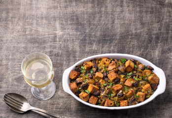 Vegan Stuffing with Mushrooms, Leeks and crunchy croutons on wooden table, top view. Thanksgiving traditional meal	