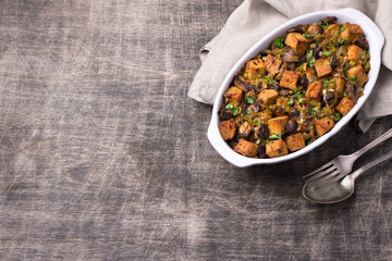 Vegan Stuffing with Mushrooms, Leeks and crunchy croutons on wooden table, top view. Thanksgiving traditional meal	