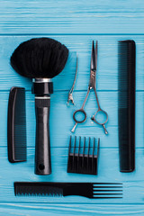 Tools for hair styling, top view. Flat lay with professional hairdresser combs and scissors.