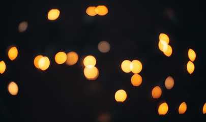 Blurred defocused xmas lights on black background