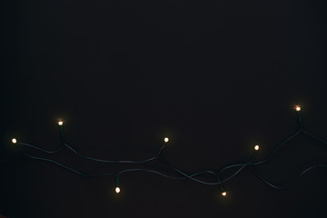 Golden Christmas garland on black background.