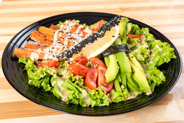 Salmon grilled salad, with herbs and lemon.