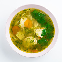 Classic chicken noodle soup with carrot and parsley isolated on white