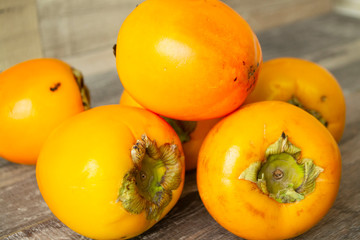 Fresh ripe orange persimmon fruit from a farm, close up.